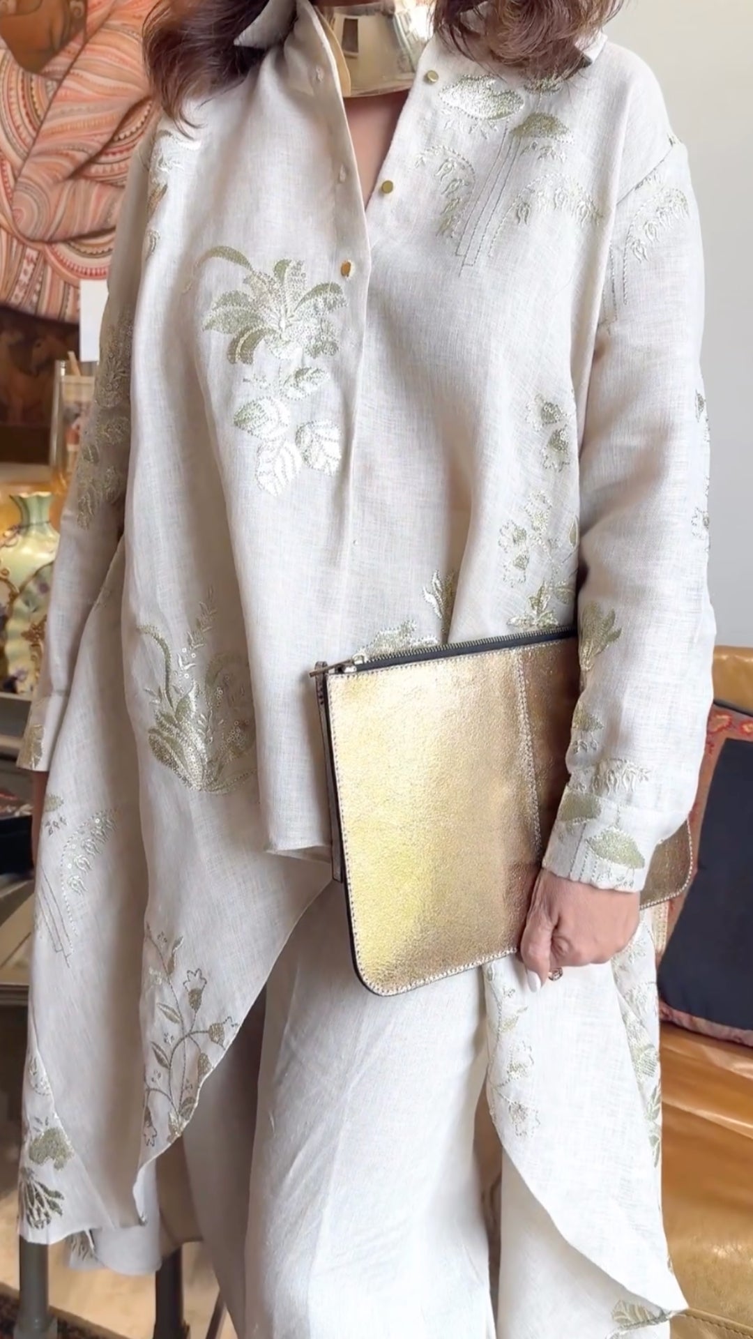 Asymmetric linen outfit featuring elegant gold embroidery, a stylish asymmetric cut, and linen pants with box pleats