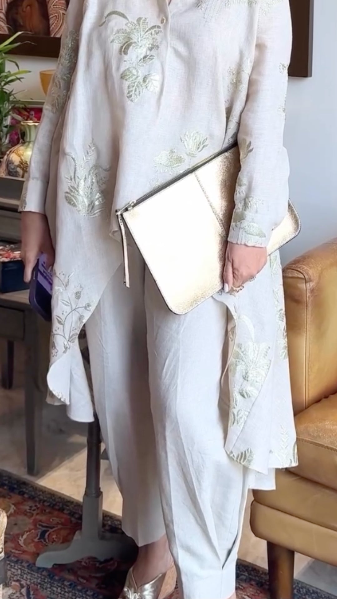 Asymmetric linen outfit featuring elegant gold embroidery, a stylish asymmetric cut, and linen pants with box pleats