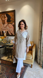 Beautiful Beige Linen dori embroidery top with lace work teamed with plain linen pants trimmed with lace
