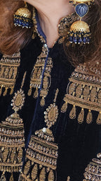 A beautiful velvet hand embroidered Zardozi jacket with satin drape skirt
