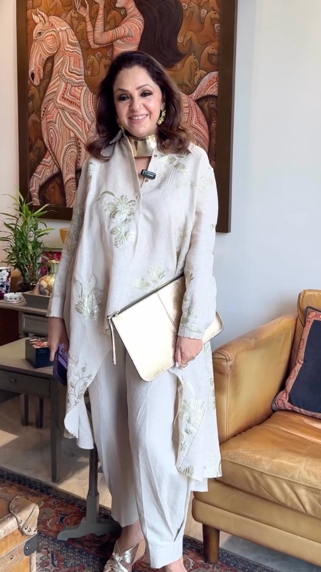 Asymmetric linen outfit featuring elegant gold embroidery, a stylish asymmetric cut, and linen pants with box pleats