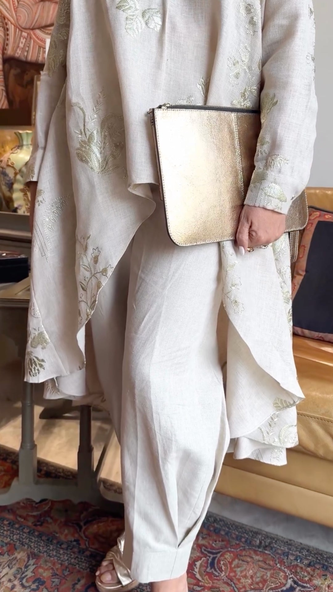 Asymmetric linen outfit featuring elegant gold embroidery, a stylish asymmetric cut, and linen pants with box pleats